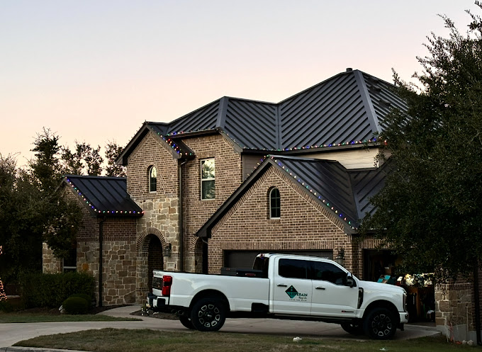 Standing seam metal roof at dusk, Hill Country home